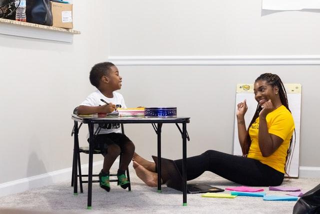 Child laughing with therapist